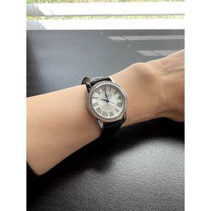 Lucien  Piccard watch, round dial face, black leather strap, calendar